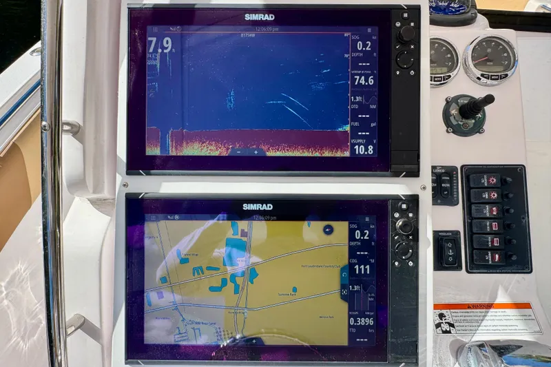 Slide: The Image of Simrad navigation displays on a 2013 Belzona 32 CC boat dashboard. - 23