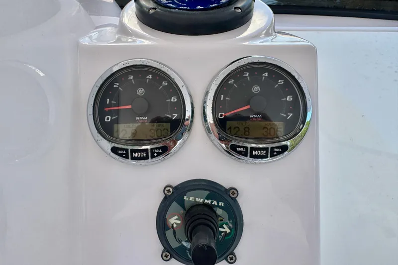 Slide: The Image of Dashboard of a 2013 Belzona 32 CC boat with RPM gauges and Lewmar control. - 24