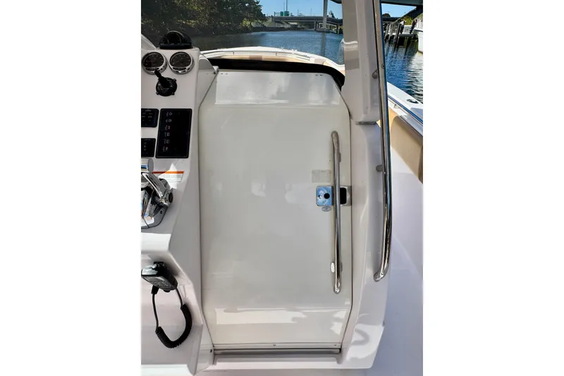Slide: The Image of 2013 Belzona 32 CC boat helm with controls and gauges, dockside view. - 26