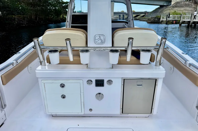 Slide: The Image of 2013 Belzona 32 CC boat interior with rod holders and storage compartments. - 32