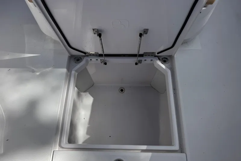 Slide: The Image of Open storage compartment on a 2013 Belzona 32 CC boat, showcasing interior space. - 35