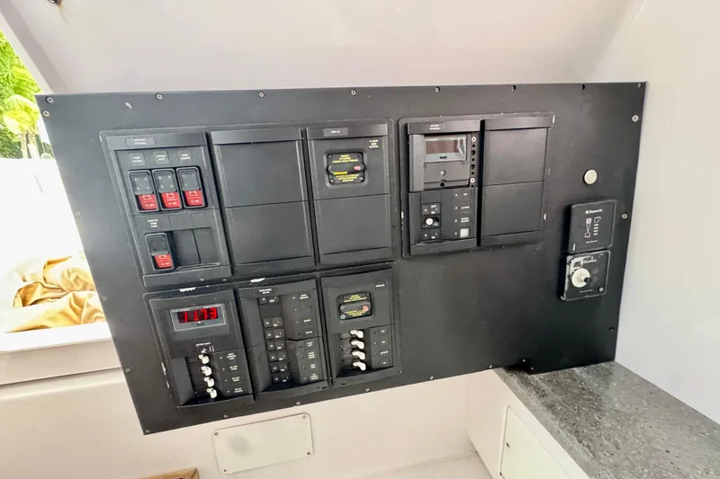 Slide: The Image of Electrical control panel on a 2013 Belzona 32 CC boat, featuring switches and gauges. - 36