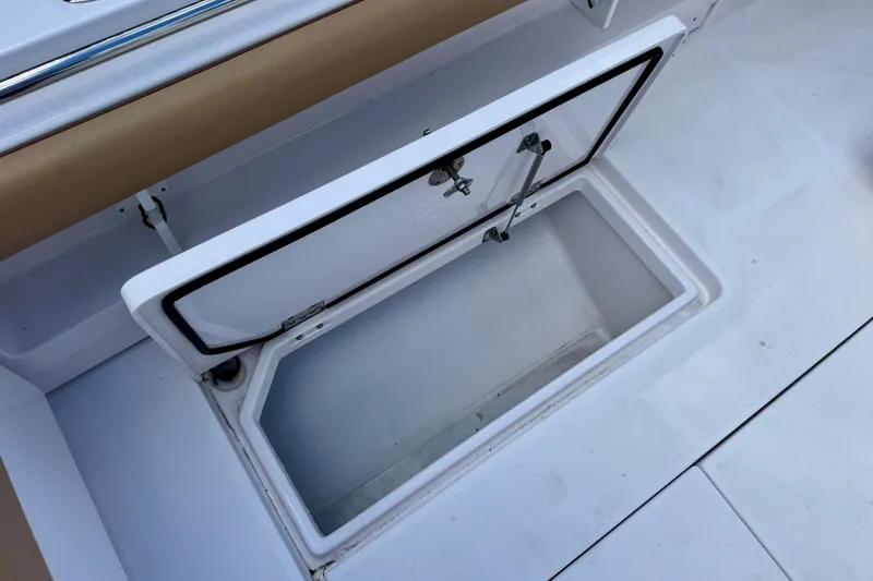 Slide: The Image of Open storage compartment on a 2013 Belzona 32 CC boat deck. - 37