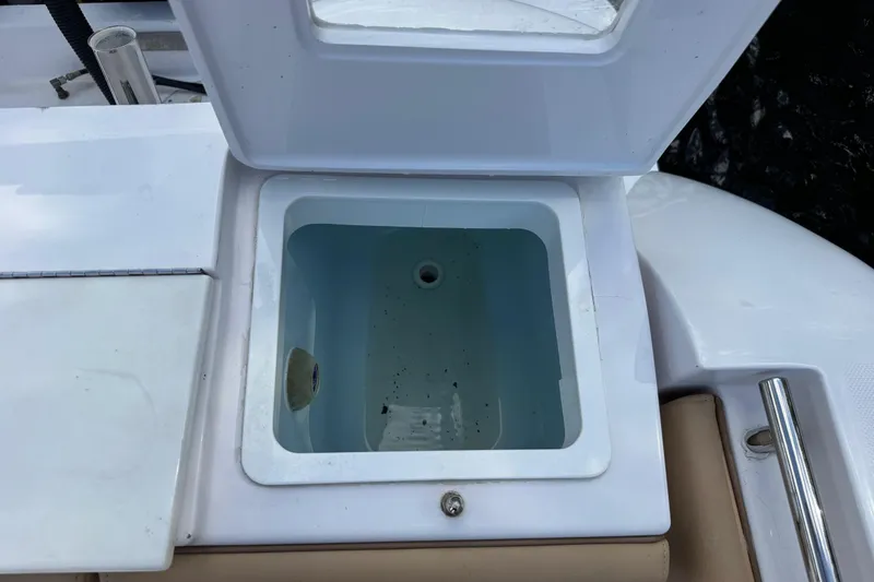 Slide: The Image of Open storage compartment on a 2013 Belzona 32 CC boat. - 38