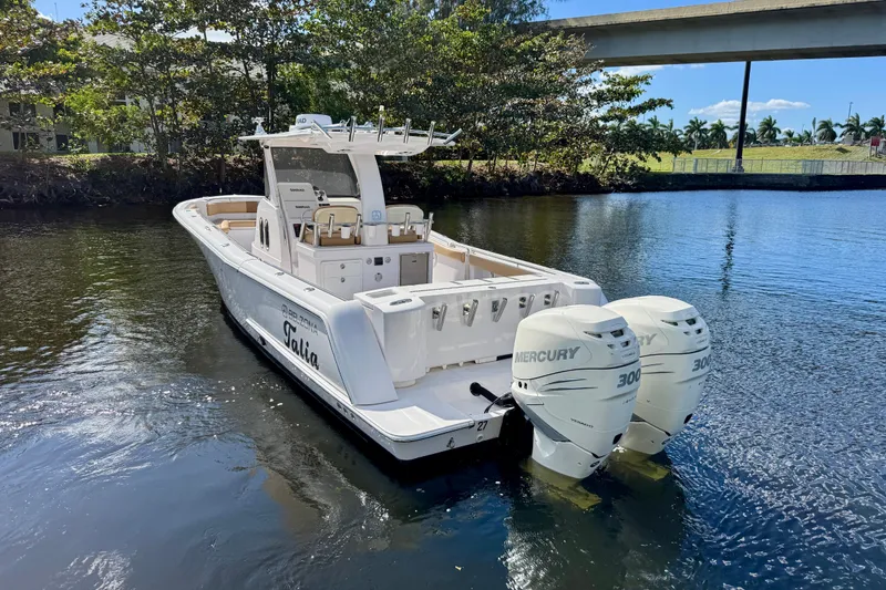 Slide: The Image of 2013 Belzona 32 CC boat with twin Mercury 300 engines on a calm waterway. - 4