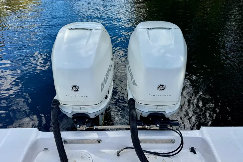 Slide: The Image of Twin Mercury FourStroke engines on a 2013 Belzona 32 CC boat, floating on water. - 40