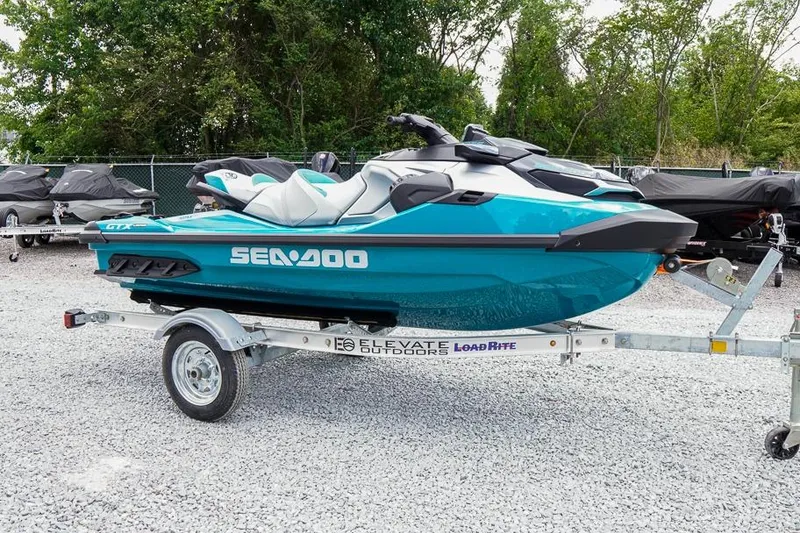 The Image of 2026 Sea-Doo GTX Limited 325 on trailer, parked outdoors, surrounded by trees. - 1