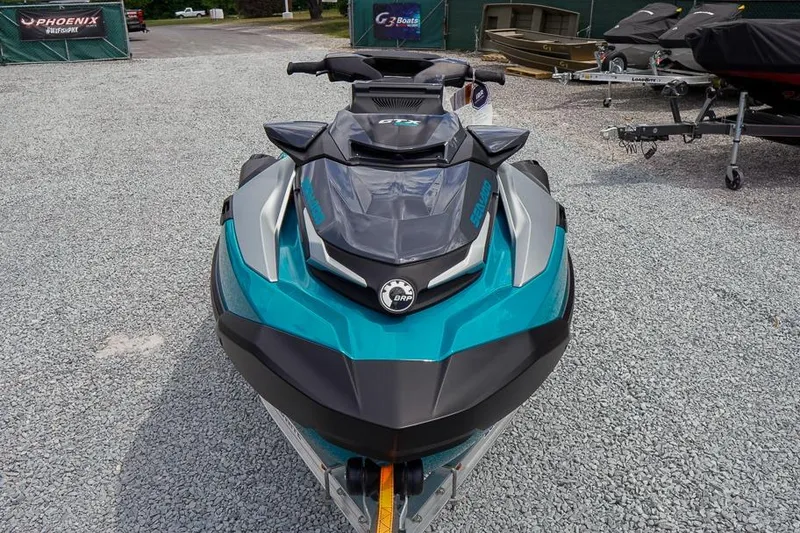 Slide: The Image of 2026 Sea-Doo GTX Limited 325 jet ski in teal and black, parked on gravel. - 10