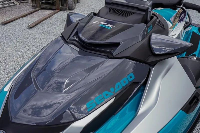 Slide: The Image of 2026 Sea-Doo GTX Limited 325 jet ski, sleek design, parked on gravel. - 11