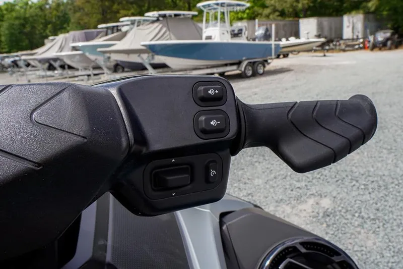Slide: The Image of Handlebar controls of 2026 Sea-Doo GTX Limited 325, featuring buttons and grip. - 15