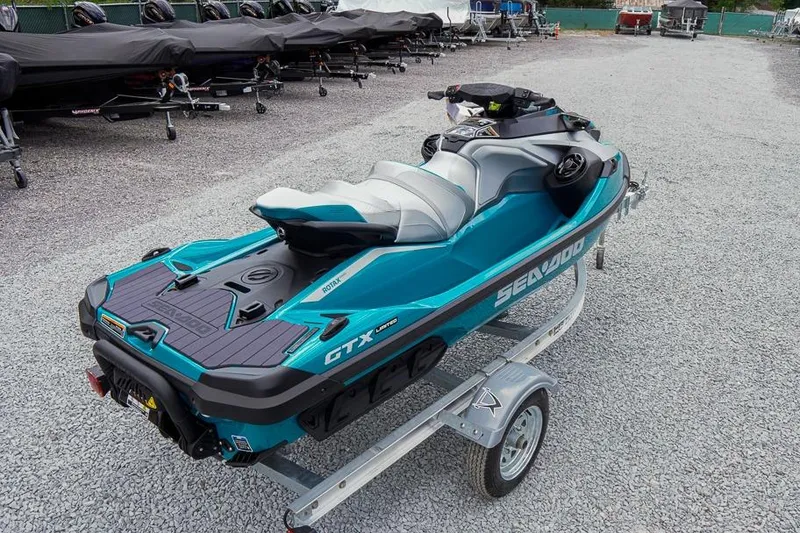 Slide: The Image of 2026 Sea-Doo GTX Limited 325 jet ski on trailer, parked on gravel lot. - 3