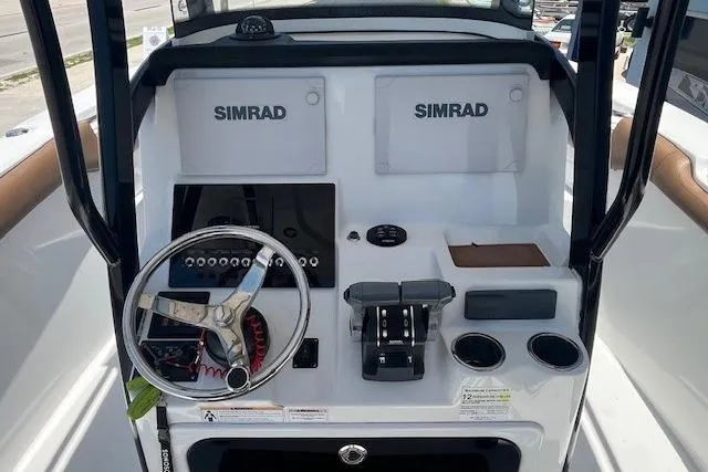 Slide: The Image of 2019 Sea Pro 259 Center Console boat dashboard with Simrad electronics and steering wheel. - 4