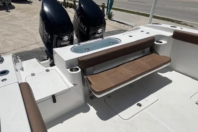 Slide: The Image of 2019 Sea Pro 259 Center Console boat with dual Suzuki 150 engines and seating area. - 6