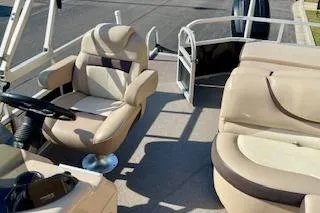 Slide: The Image of 2016 Sun Tracker Party Barge 22 XP3 interior with beige seating and steering console. - 13
