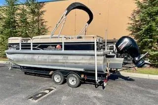 Slide: The Image of 2016 Sun Tracker Party Barge 22 XP3 pontoon boat on trailer, parked outdoors. - 3