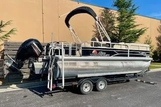 Slide: The Image of 2016 Sun Tracker Party Barge 22 XP3 pontoon boat on trailer, parked outdoors. - 4