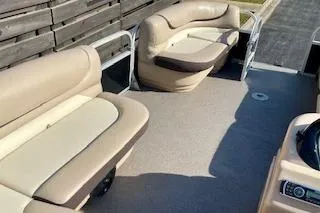 Slide: The Image of 2016 Sun Tracker Party Barge 22 XP3 interior with beige seating and spacious deck. - 8