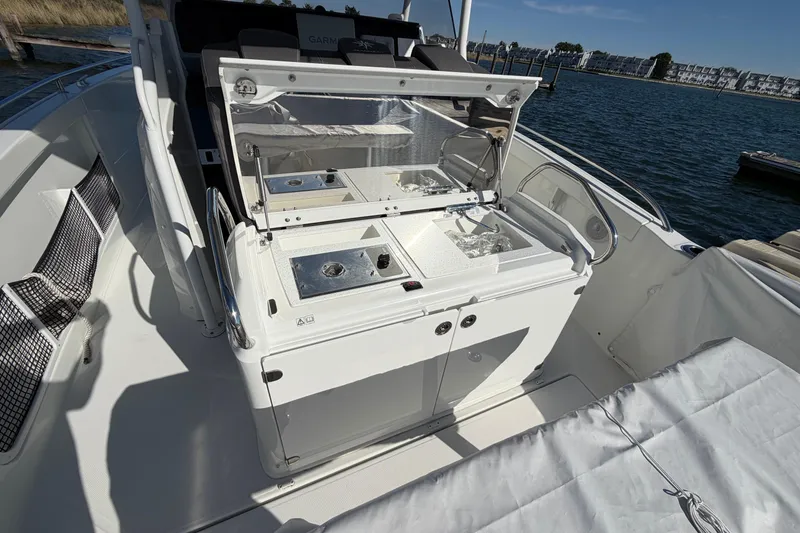 Slide: The Image of 2024 Jeanneau Leader 9.0 CC boat interior with open storage compartments and sleek design. - 12