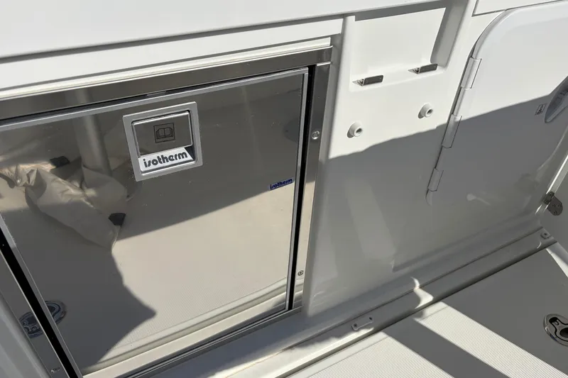 Slide: The Image of 2024 Jeanneau Leader 9.0 CC boat interior featuring an Isotherm refrigerator. - 18