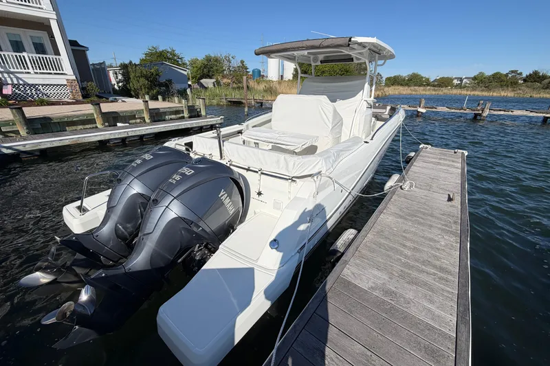 Slide: The Image of 2024 Jeanneau Leader 9.0 CC boat docked with twin Yamaha engines. - 2