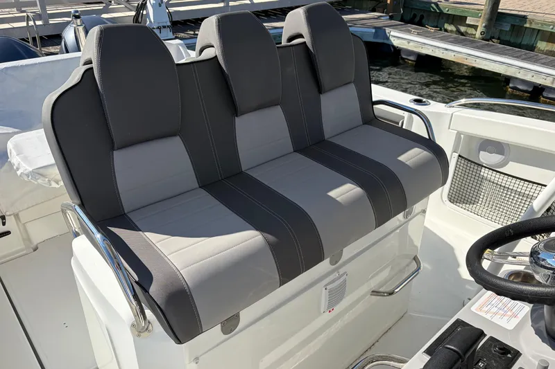 Slide: The Image of 2024 Jeanneau Leader 9.0 CC boat seating, featuring sleek gray upholstery and modern design. - 4