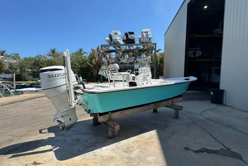 The Image of 2005 Kenner 21 VX boat with Suzuki outboard motor on a dock. - 1