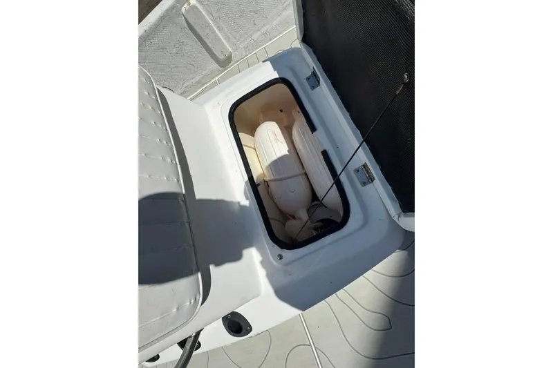Slide: The Image of Open storage compartment on a 2005 Kenner 21 VX boat, showing interior details. - 10