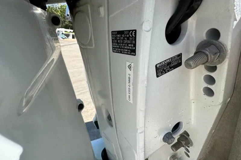 Slide: The Image of Close-up of a 2005 Kenner 21 VX boat's engine mount with visible labels and bolts. - 5