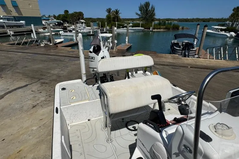 Slide: The Image of 2005 Kenner 21 VX boat at marina with Suzuki outboard motor. - 7