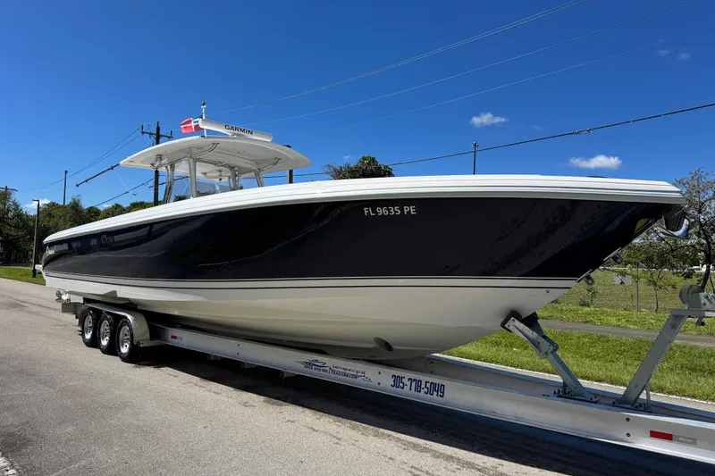 Slide: The Image of 2012 Intrepid 400 Center Console boat on trailer under clear blue sky. - 13