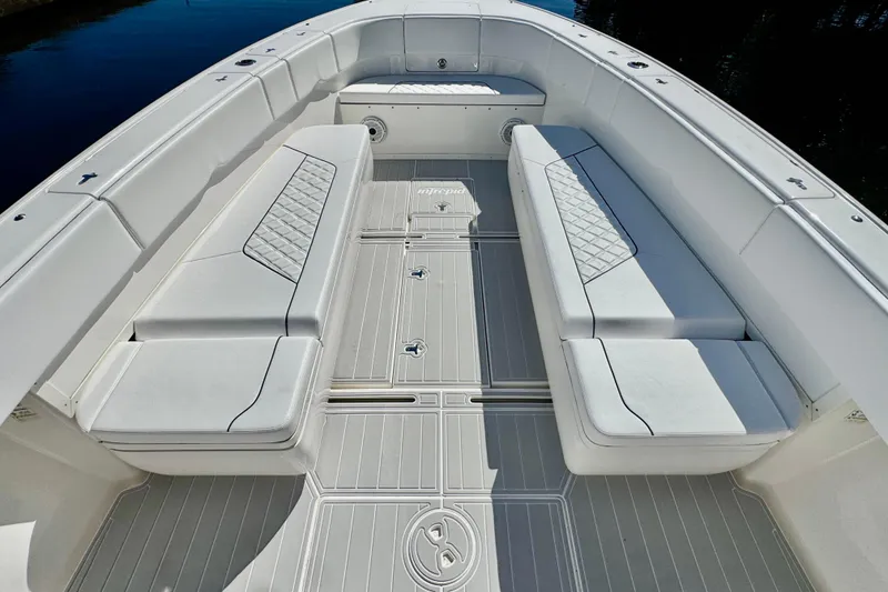 Slide: The Image of 2012 Intrepid 400 Center Console boat interior with white cushioned seating and sleek design. - 14