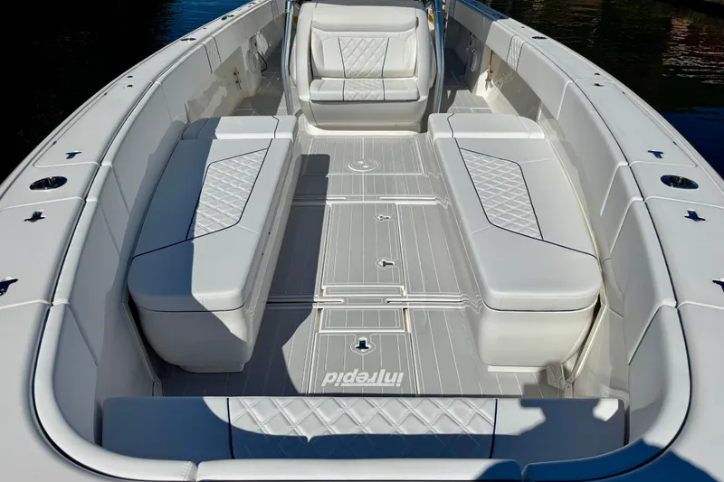 Slide: The Image of 2012 Intrepid 400 Center Console boat interior with white cushioned seating. - 15