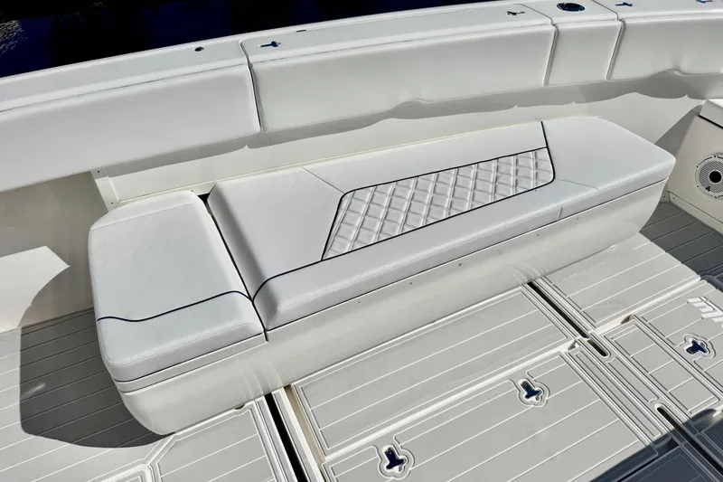 Slide: The Image of White seating on 2012 Intrepid 400 Center Console boat, featuring diamond-patterned upholstery. - 16