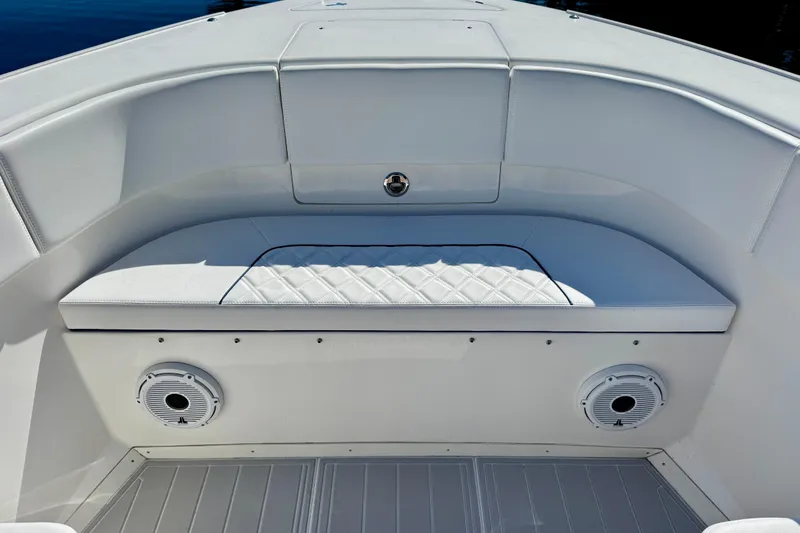 Slide: The Image of Luxurious seating on 2012 Intrepid 400 Center Console boat, featuring white upholstery and speakers. - 17