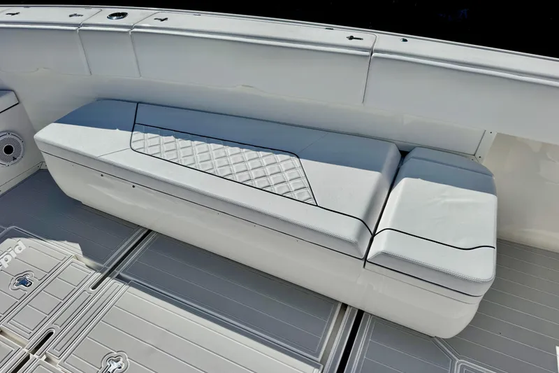 Slide: The Image of White seating on a 2012 Intrepid 400 Center Console boat, featuring diamond-pattern upholstery. - 18