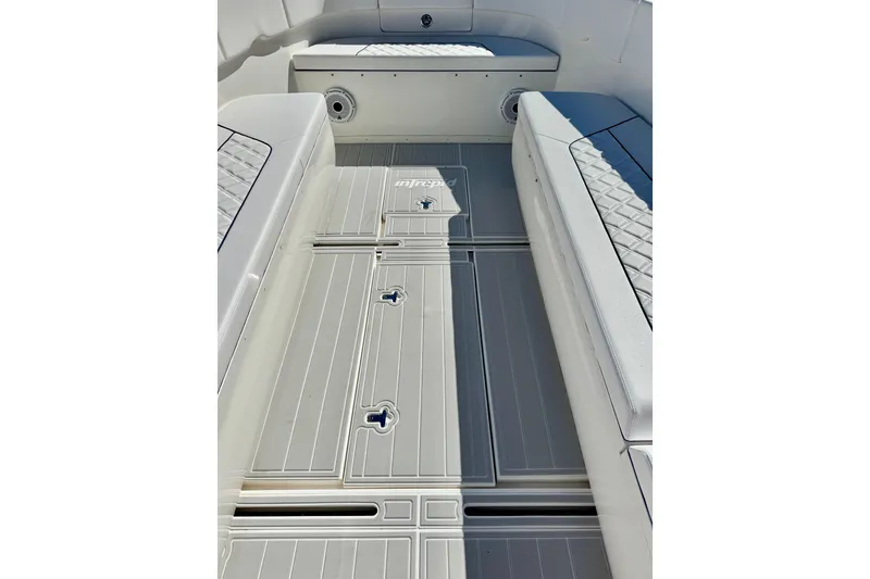 Slide: The Image of 2012 Intrepid 400 Center Console boat interior with cushioned seating and sleek flooring. - 19
