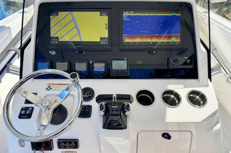 Slide: The Image of Control panel of a 2012 Intrepid 400 Center Console with navigation screens and steering wheel. - 22