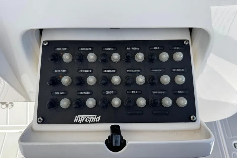 Slide: The Image of Control panel of a 2012 Intrepid 400 Center Console boat with labeled switches. - 26