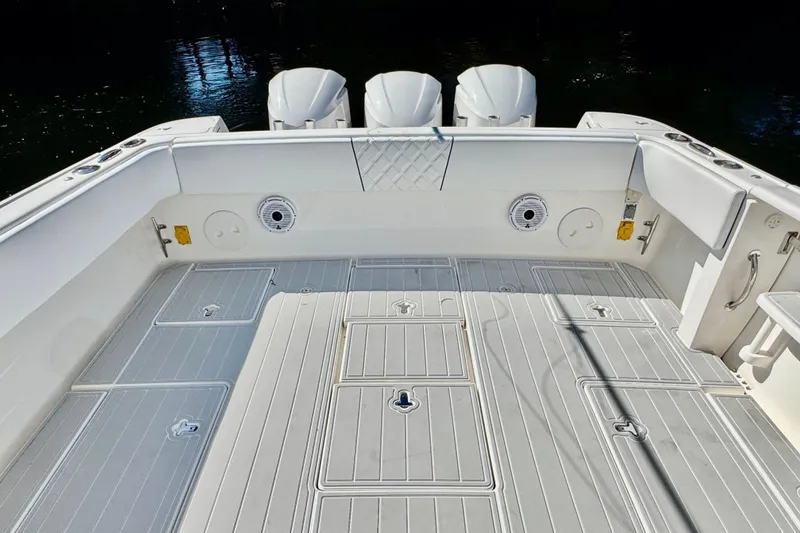 Slide: The Image of 2012 Intrepid 400 Center Console boat deck with triple engines, featuring spacious layout. - 29