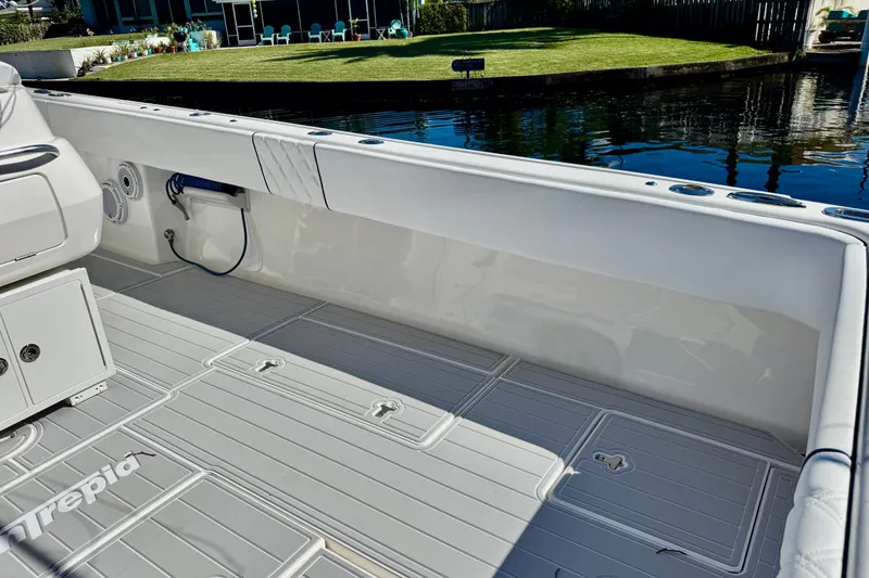Slide: The Image of 2012 Intrepid 400 Center Console boat interior with sleek deck and seating by the water. - 31