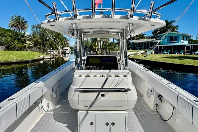 Slide: The Image of 2012 Intrepid 400 Center Console boat docked on a sunny canal. - 32