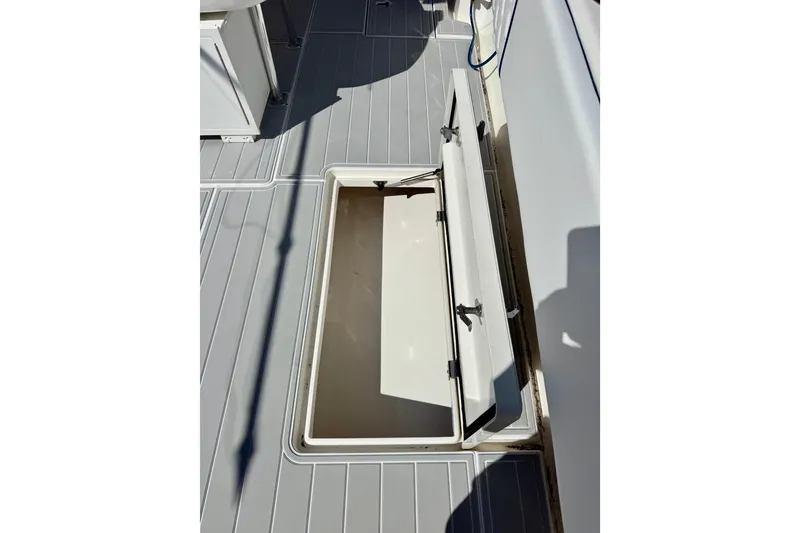 Slide: The Image of Open storage compartment on 2012 Intrepid 400 Center Console boat deck. - 33