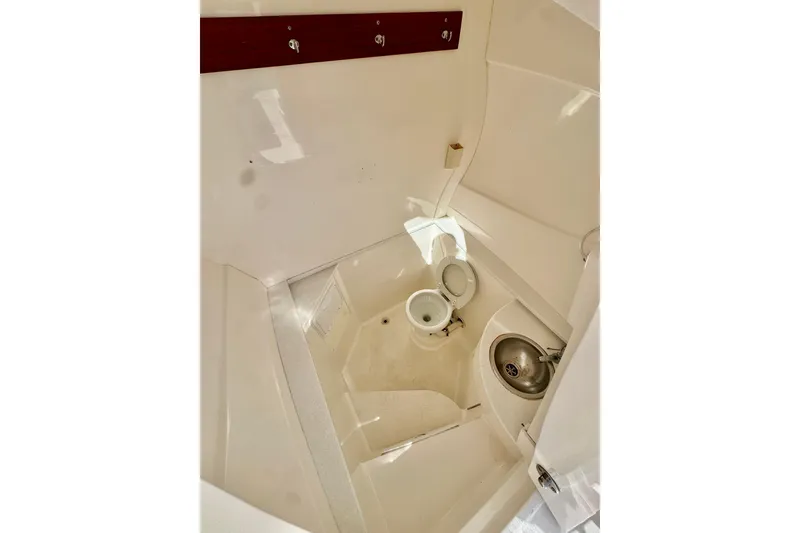 Slide: The Image of Interior of 2012 Intrepid 400 Center Console boat bathroom with toilet and sink. - 35