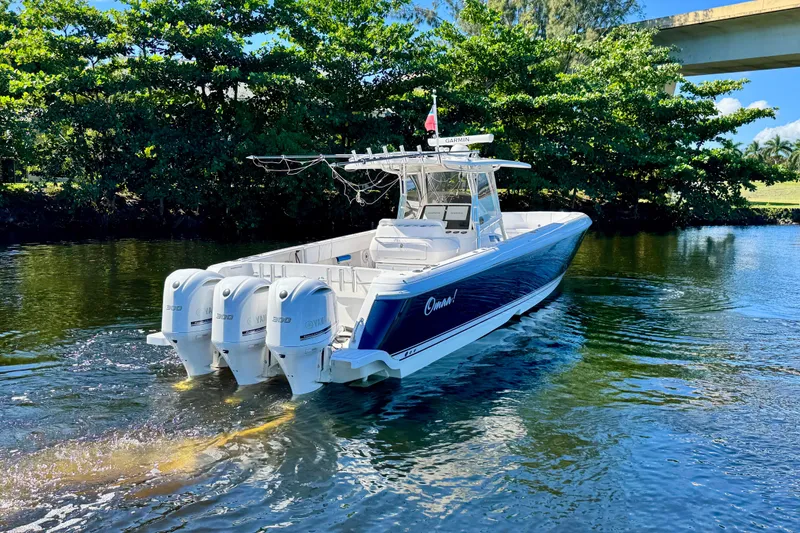 Slide: The Image of 2012 Intrepid 400 Center Console boat with four Yamaha engines on a calm waterway. - 5