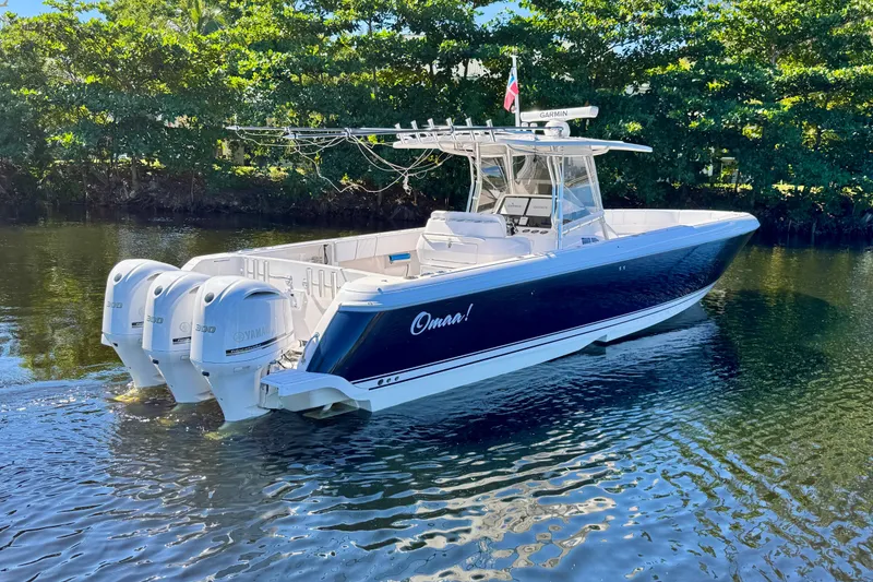 Slide: The Image of 2012 Intrepid 400 Center Console boat with triple Yamaha engines on calm water. - 6