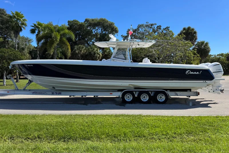 Slide: The Image of 2012 Intrepid 400 Center Console boat on trailer, surrounded by lush greenery. - 8