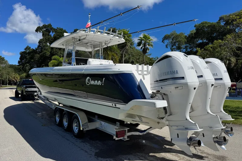 Slide: The Image of 2012 Intrepid 400 Center Console boat with triple Yamaha engines on a trailer. - 9