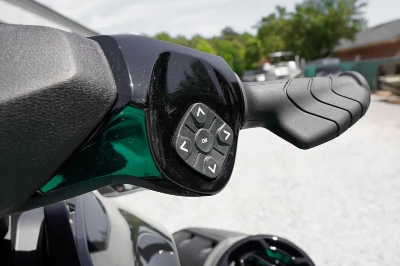 Slide: The Image of Close-up of 2026 Sea-Doo GTI SE 170 handlebar controls, featuring ergonomic grip and navigation buttons. - 11