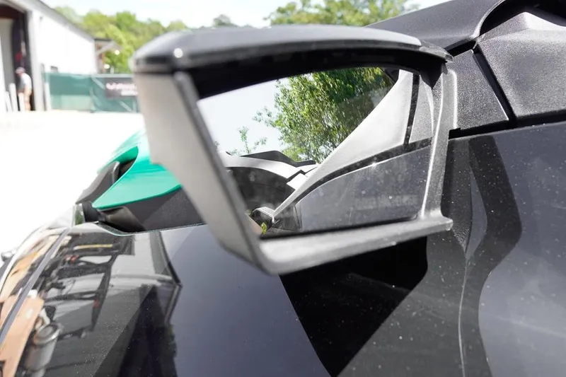 Slide: The Image of Close-up of 2026 Sea-Doo GTI SE 170 side mirror reflecting outdoor scenery. - 15