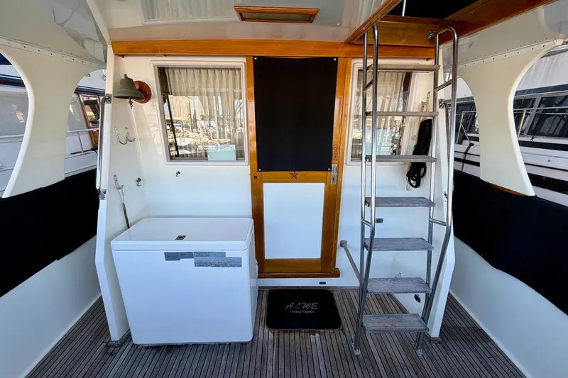 Slide: The Image of Interior of 1991 Grand Banks 36 Europa yacht with wooden door and metal ladder. - 11